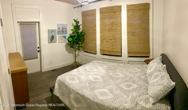 a bedroom with a bed and a potted plant