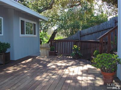 80 Half Moon Road Novato, CA 94947 - Photo 4 of 12 a view of a backyard with a large tree and wooden fence