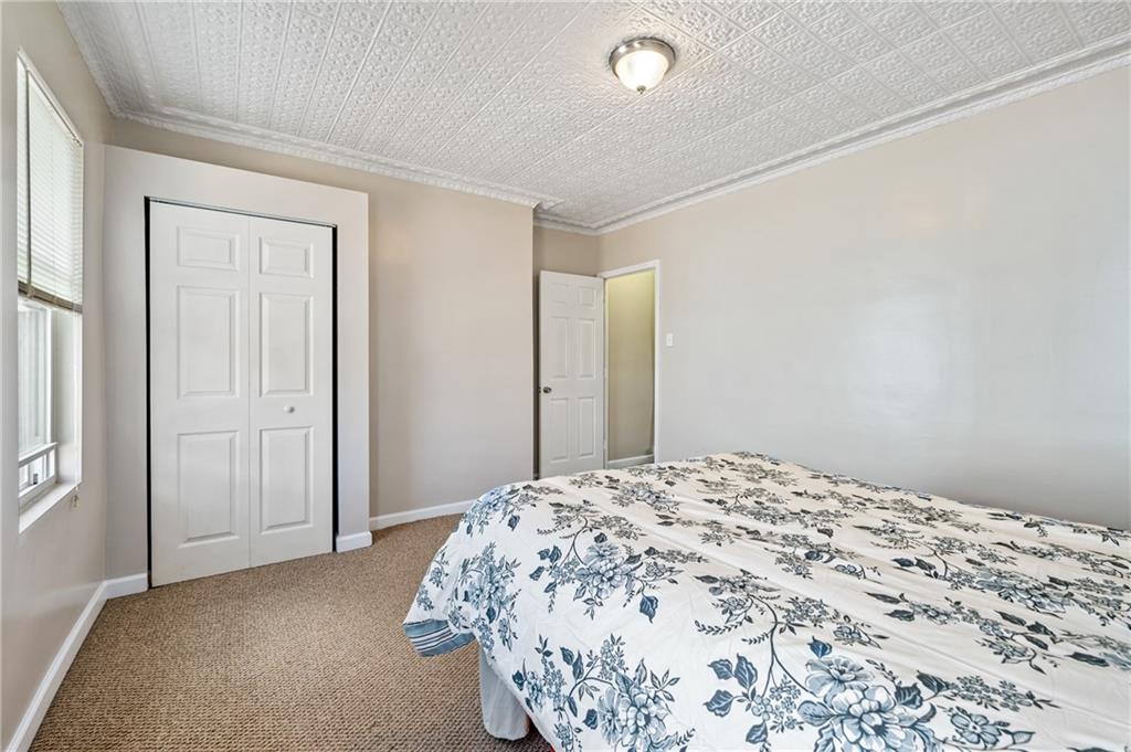 4524 Minerva Street Pittsburgh, PA 15224 - Photo 16 of 28 a bedroom with a bed and a window