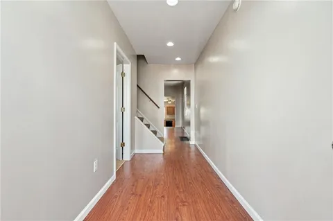 a view of a hallway with wooden floor