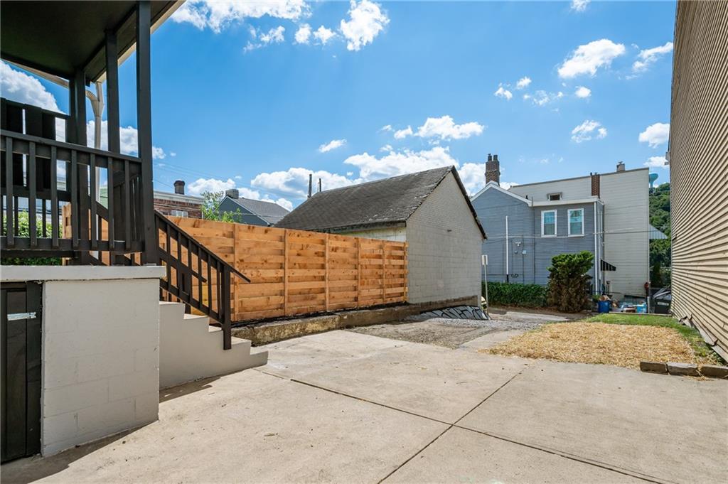 4524 Minerva Street Pittsburgh, PA 15224 - Photo 22 of 28 a view of a house with a wooden fence