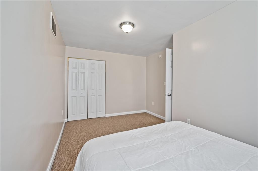 4524 Minerva Street Pittsburgh, PA 15224 - Photo 26 of 28 a bedroom with a bed and a window