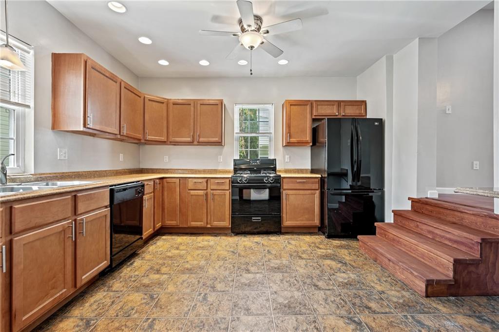 4524 Minerva Street Pittsburgh, PA 15224 - Photo 7 of 28 a kitchen with stainless steel appliances granite countertop a refrigerator and a sink