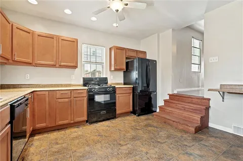 a kitchen with a refrigerator and a sink
