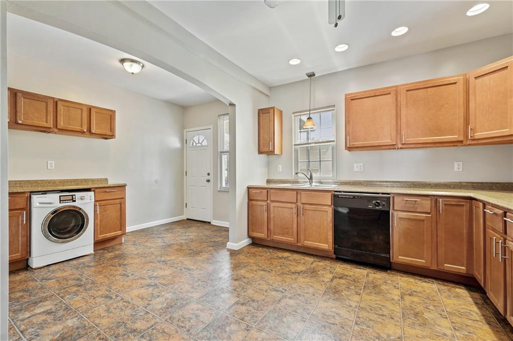 4524 Minerva Street Pittsburgh, PA 15224 - Photo 9 of 28 a kitchen with a sink a stove and cabinets