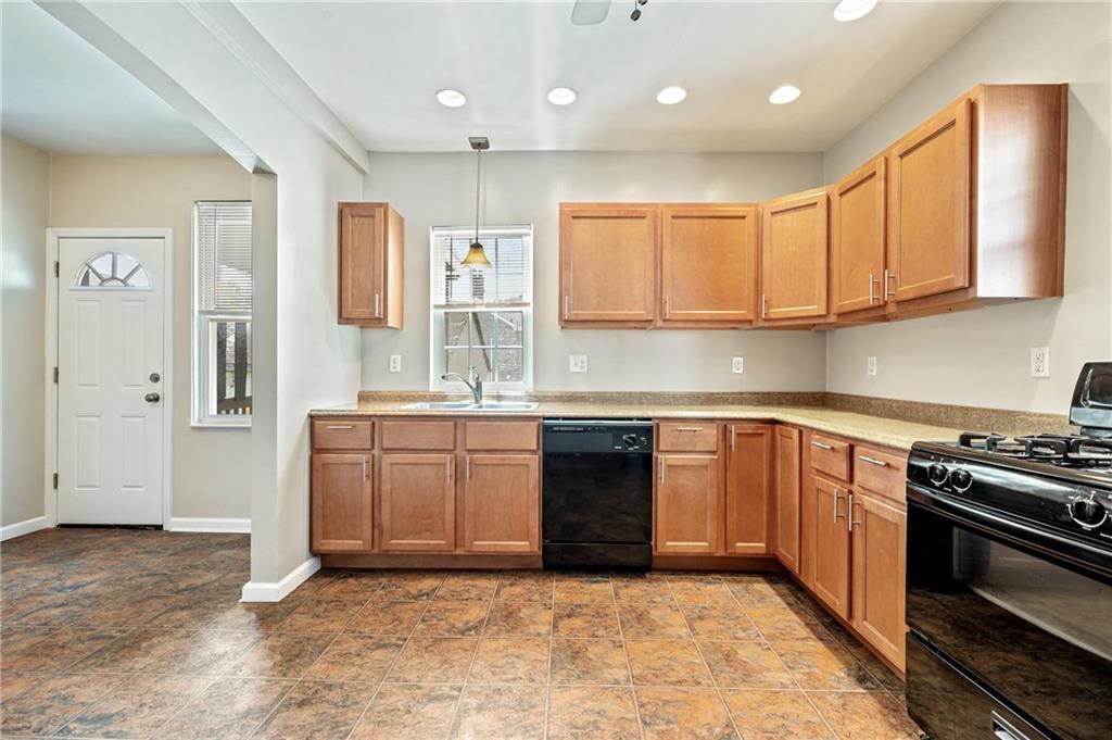 4524 Minerva Street Pittsburgh, PA 15224 - Photo 10 of 28 a kitchen with stainless steel appliances granite countertop a stove a sink and a refrigerator