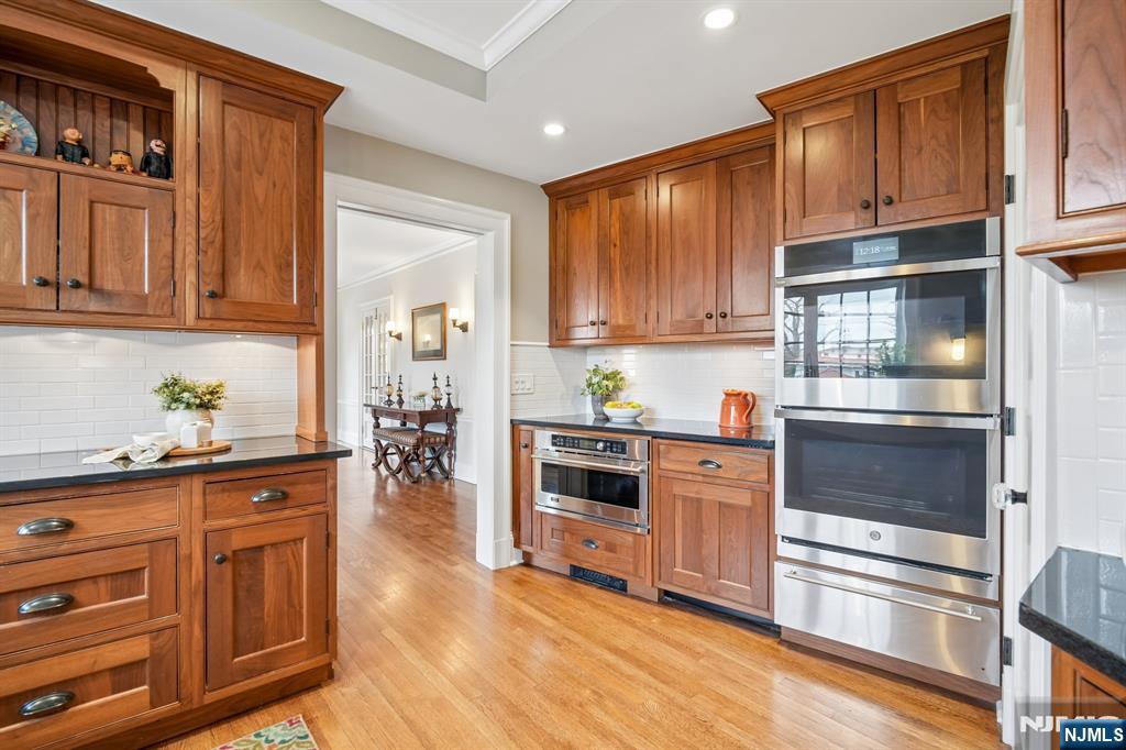 29 Hillcrest Road Glen Ridge, NJ 07028 - Photo 24 of 44 a kitchen with granite countertop wooden cabinets and stainless steel appliances