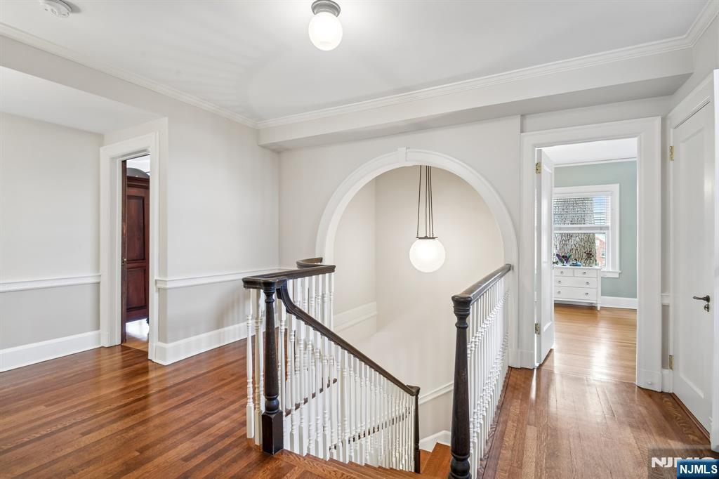 29 Hillcrest Road Glen Ridge, NJ 07028 - Photo 26 of 44 a view of a hallway with wooden floor and staircase