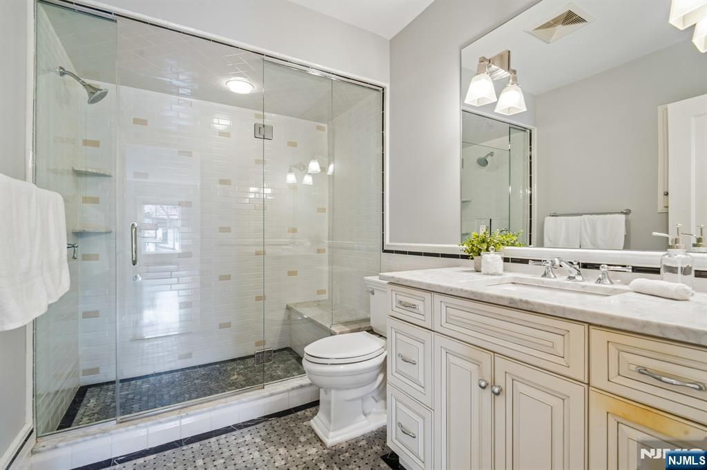 29 Hillcrest Road Glen Ridge, NJ 07028 - Photo 29 of 44 a bathroom with a double vanity sink toilet and shower
