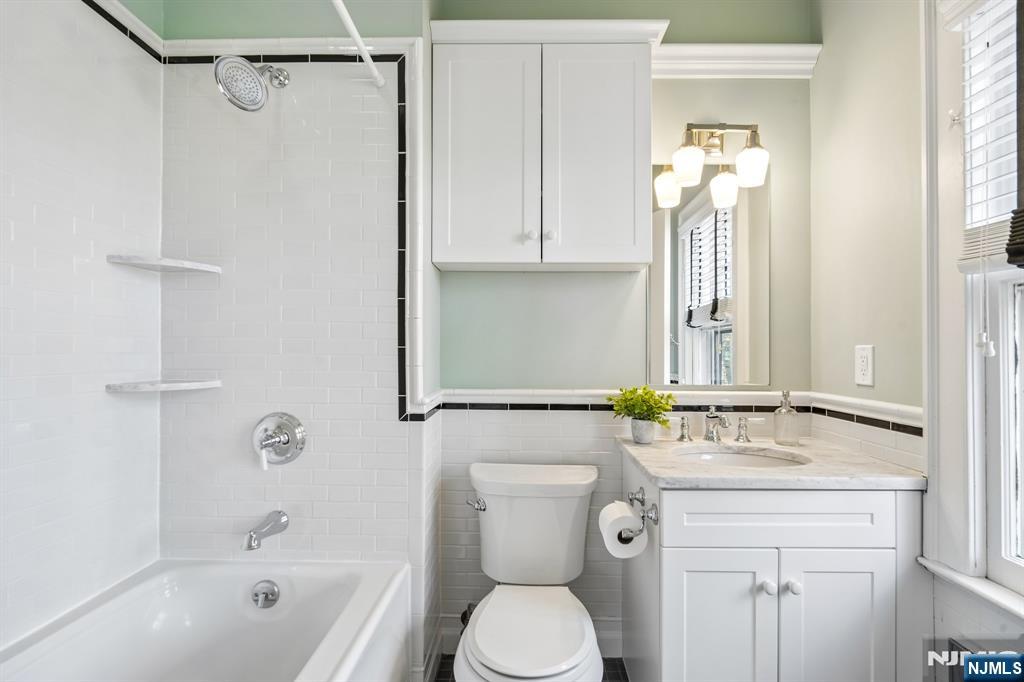 29 Hillcrest Road Glen Ridge, NJ 07028 - Photo 32 of 44 a bathroom with a granite countertop sink a toilet and shower