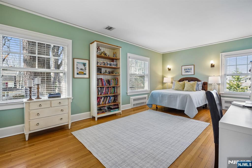 29 Hillcrest Road Glen Ridge, NJ 07028 - Photo 33 of 44 a bedroom with a bed and a cabinets