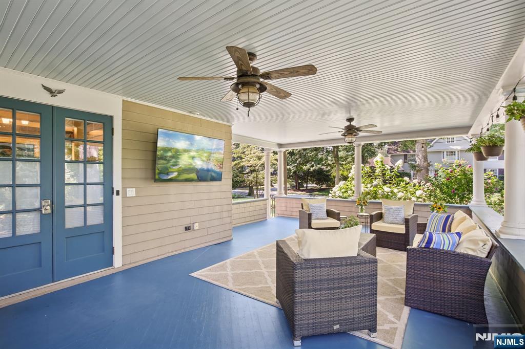 29 Hillcrest Road Glen Ridge, NJ 07028 - Photo 4 of 44 a living room with furniture a flat screen tv and a large window