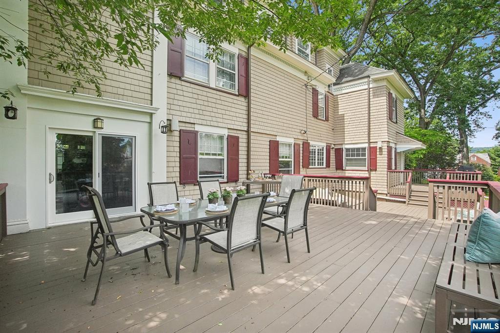 29 Hillcrest Road Glen Ridge, NJ 07028 - Photo 7 of 44 a view of a dinning table and chairs in patio of the house