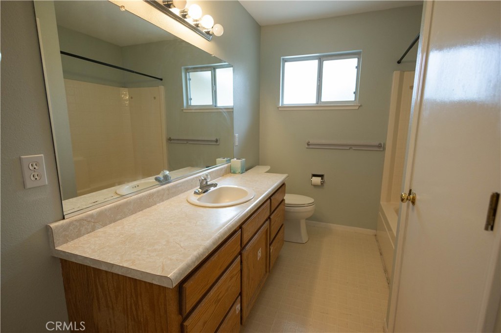 6042 Grange Road Corning, CA 96021 - Photo 17 of 38 a bathroom with a sink a toilet and a mirror