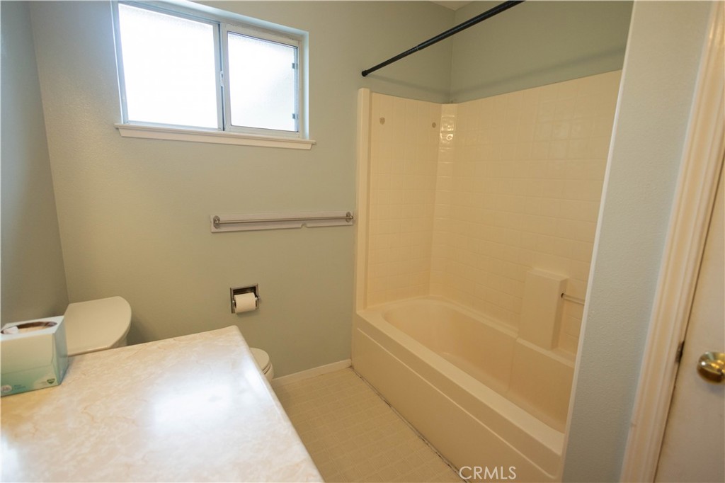 6042 Grange Road Corning, CA 96021 - Photo 18 of 38 a bathroom with a bathtub and a shower