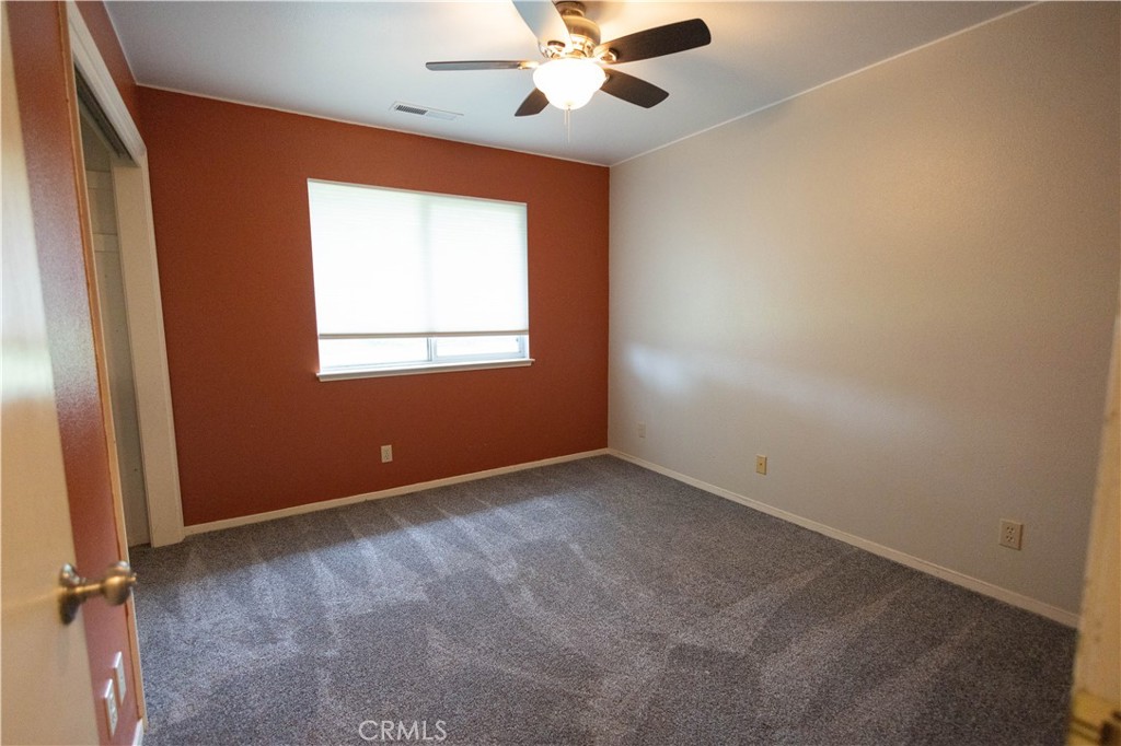 6042 Grange Road Corning, CA 96021 - Photo 21 of 38 an empty room with a window and a fan