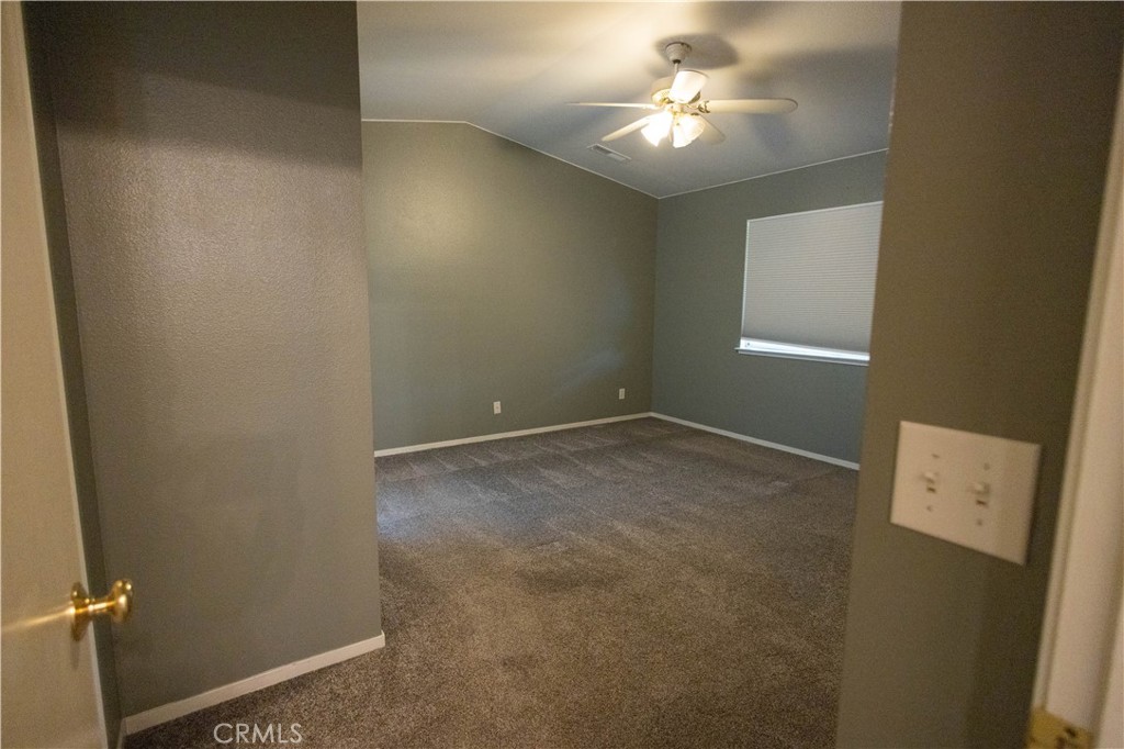 6042 Grange Road Corning, CA 96021 - Photo 23 of 38 an empty room with a window and a fan