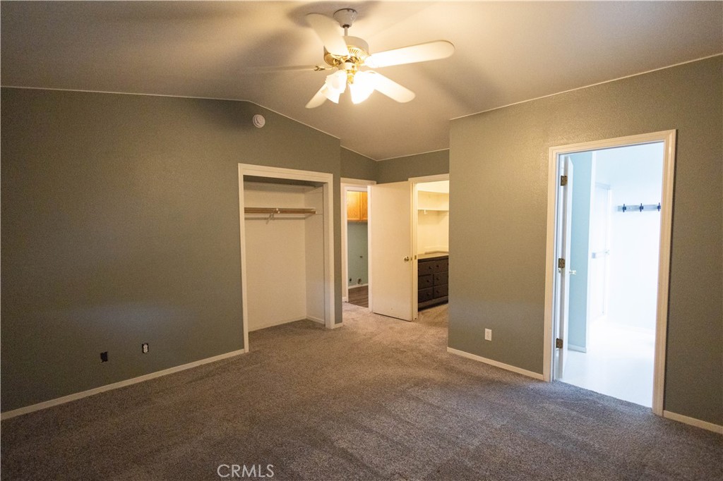 6042 Grange Road Corning, CA 96021 - Photo 24 of 38 an empty room with closet and a chandelier fan