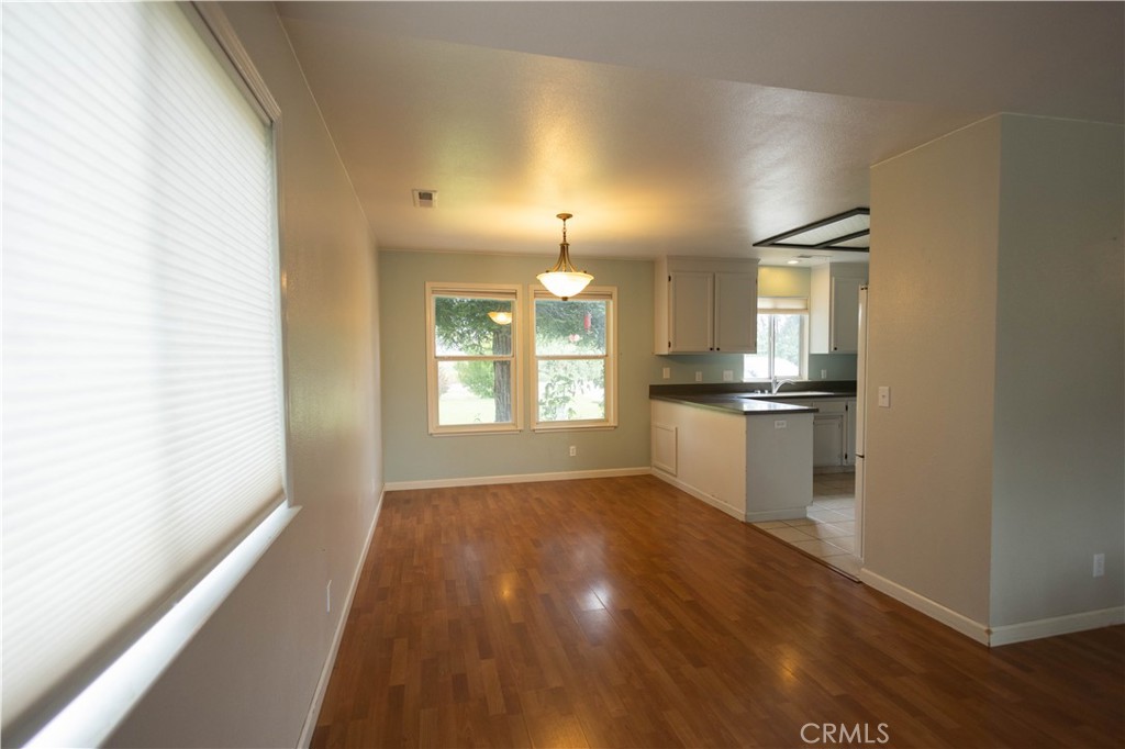 6042 Grange Road Corning, CA 96021 - Photo 5 of 38 a view of a kitchen with wooden floor and a kitchen