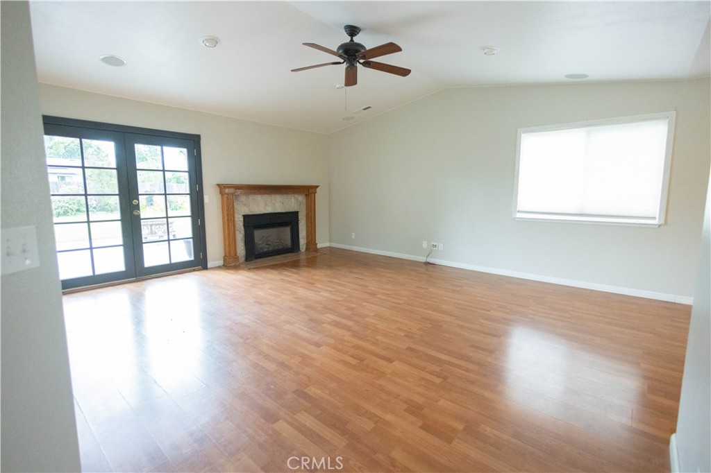 6042 Grange Road Corning, CA 96021 - Photo 8 of 38 wooden floor chandelier and windows in a room