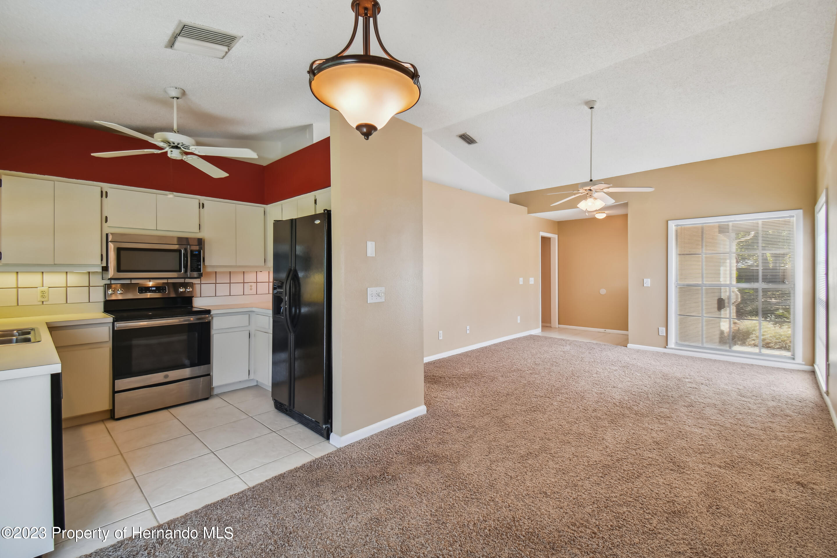 1735 Elk Spring Drive Brandon, FL 33511 - Photo 17 of 49 a open kitchen with stainless steel appliances granite countertop a refrigerator and a stove top oven
