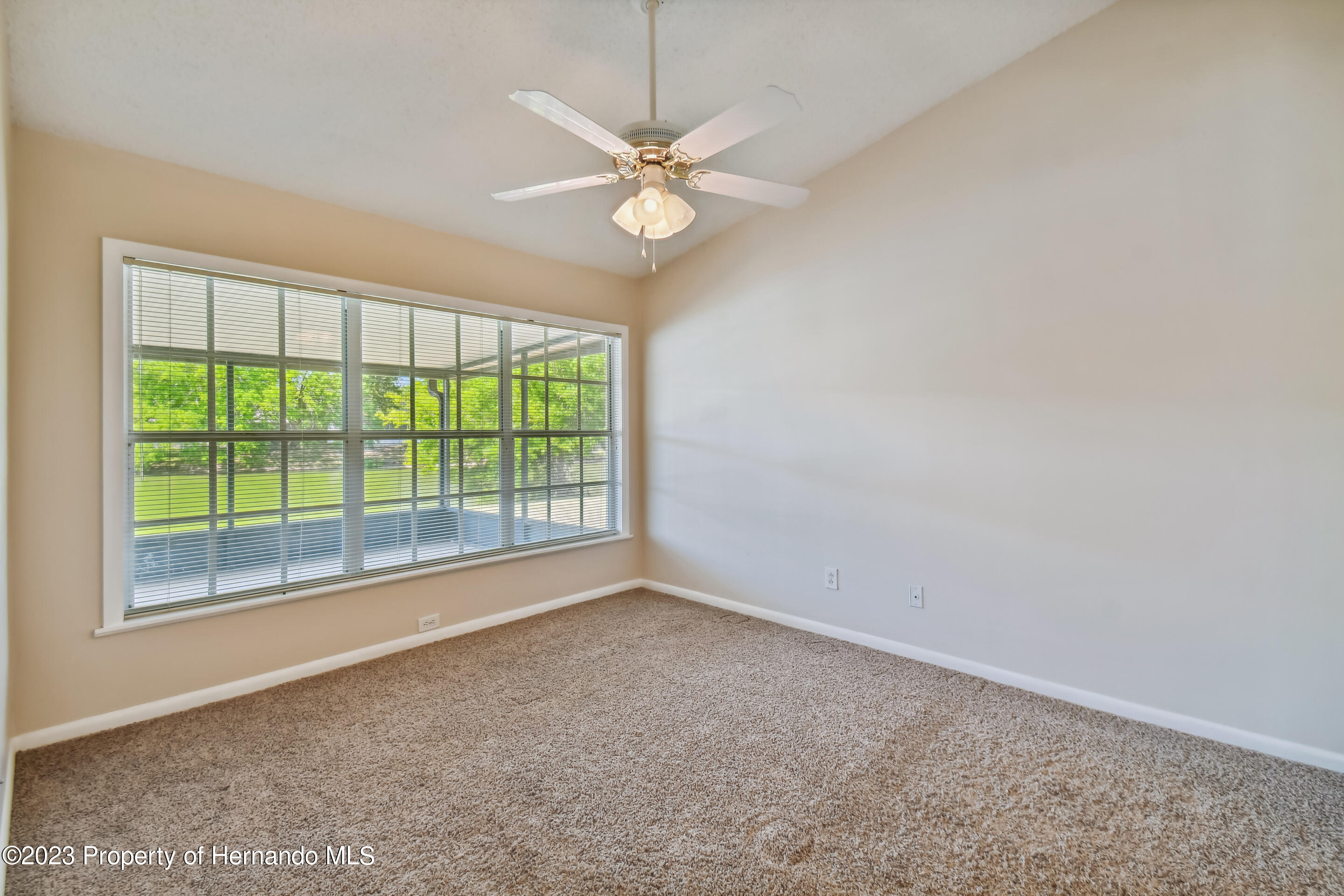 1735 Elk Spring Drive Brandon, FL 33511 - Photo 22 of 49 a view of a livingroom with a ceiling fan and a large window