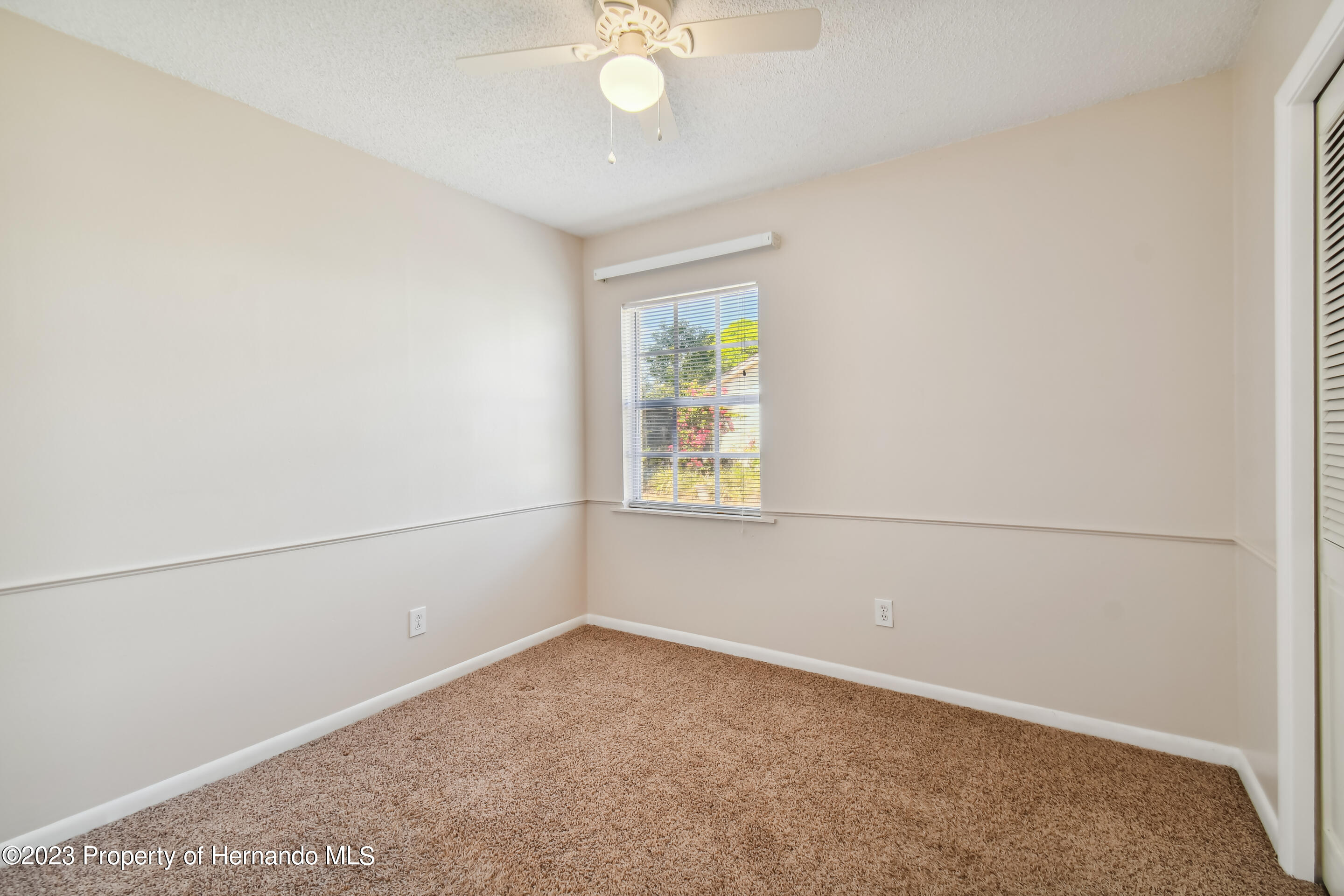 1735 Elk Spring Drive Brandon, FL 33511 - Photo 6 of 49 an empty room with a window