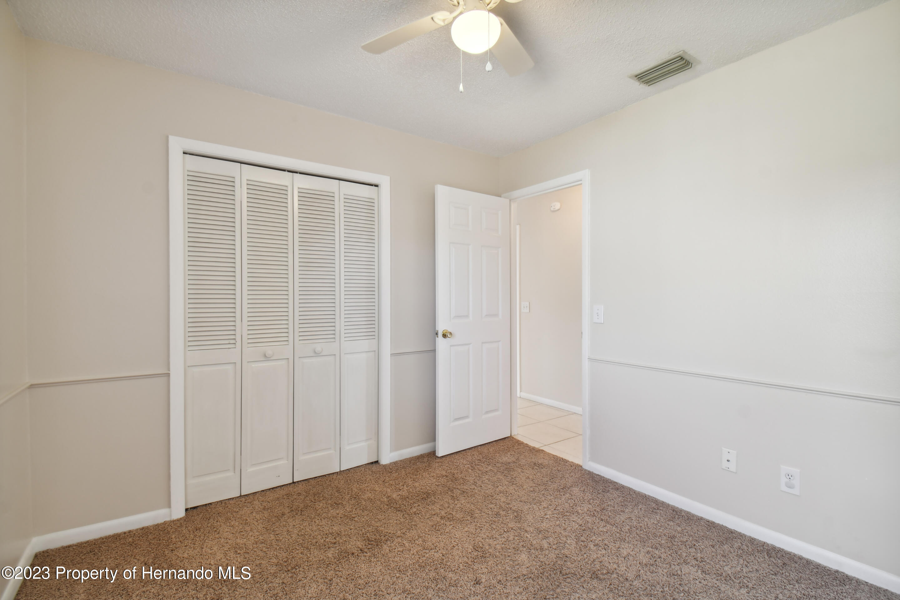 1735 Elk Spring Drive Brandon, FL 33511 - Photo 7 of 49 an empty room with a ceiling fan and a window