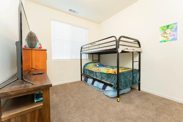 a bedroom with a bed and a window