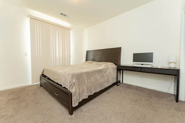 a bedroom with a bed and window