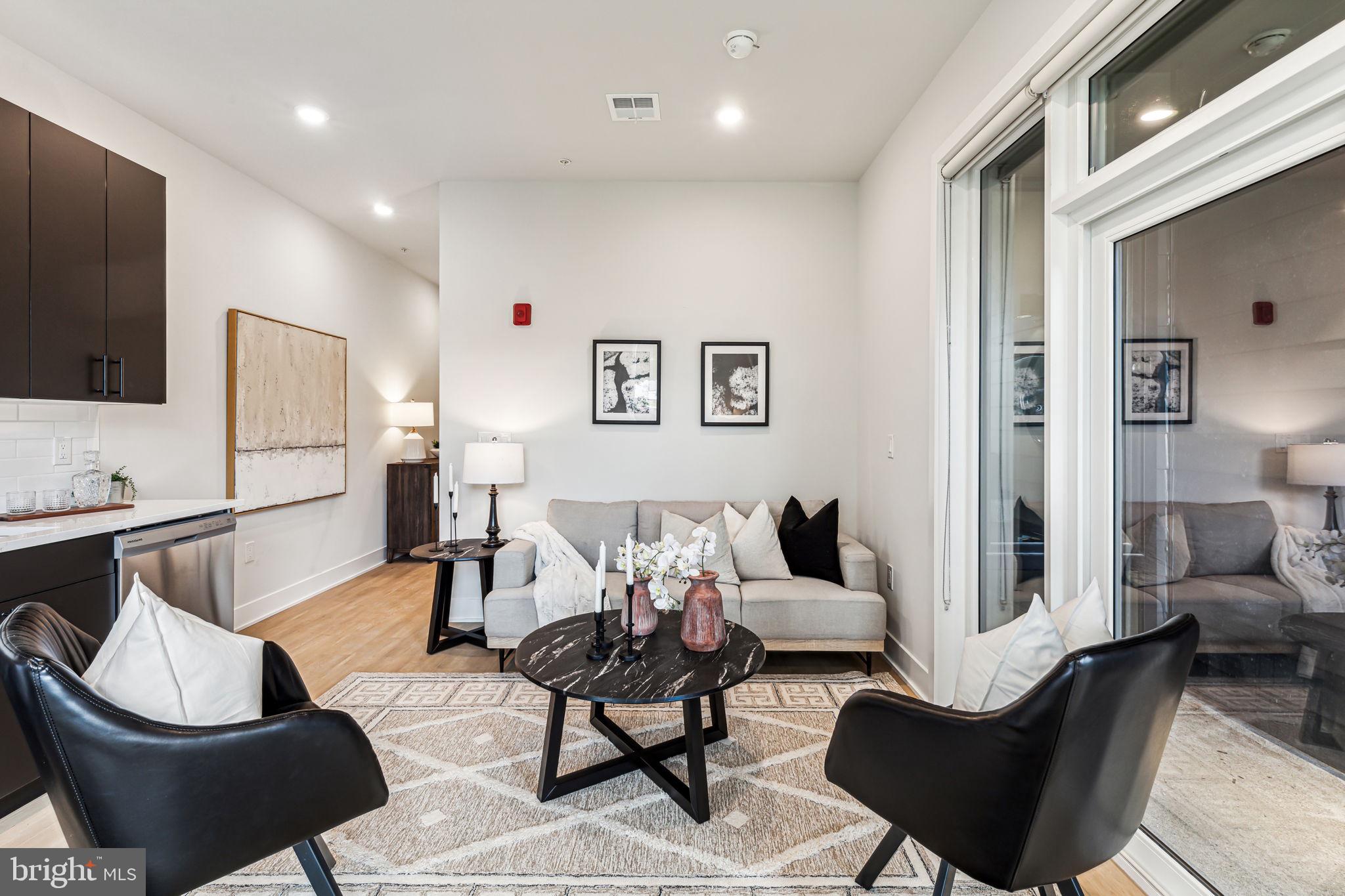 6910 Ridge Avenue, Unit 420 Philadelphia, PA 19128 - Photo 3 of 18 a living room with furniture and a flat screen tv