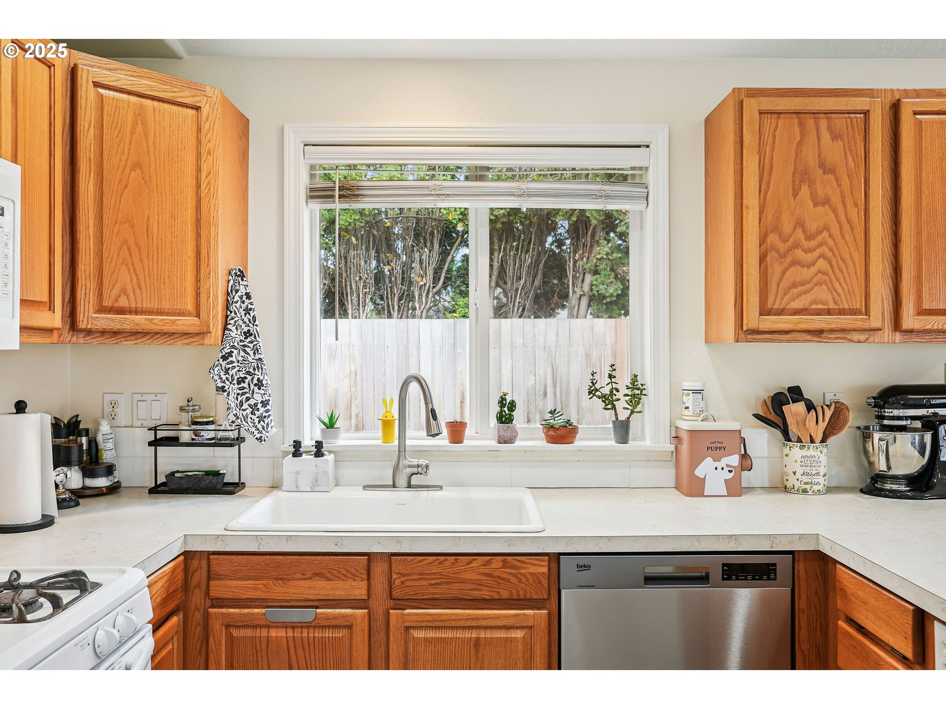 591 Southwest Filbert Street McMinnville, OR 97128 - Photo 13 of 34 a kitchen with stainless steel appliances a sink a stove and a window