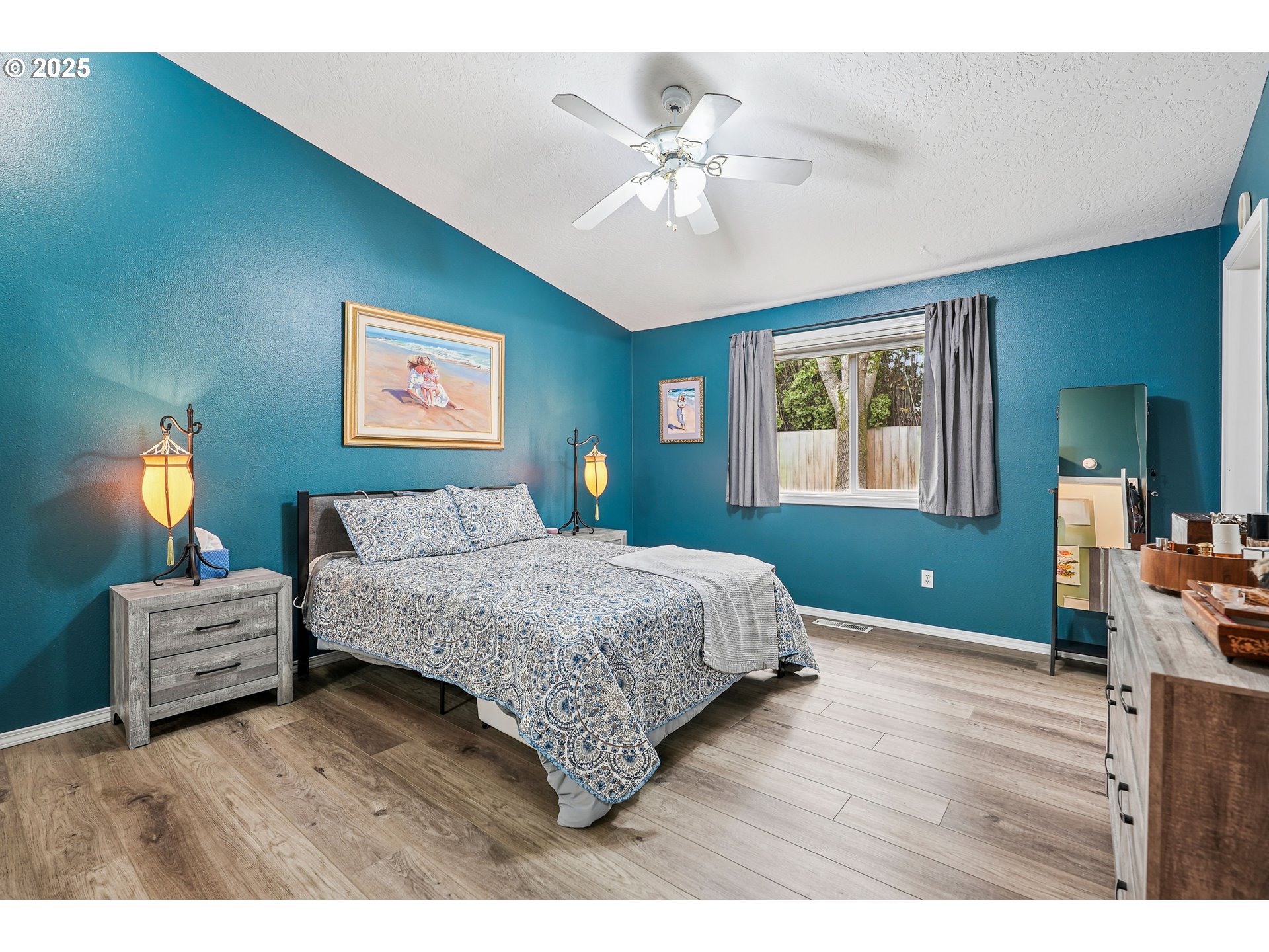 591 Southwest Filbert Street McMinnville, OR 97128 - Photo 15 of 34 a bedroom with a bed and a chandelier