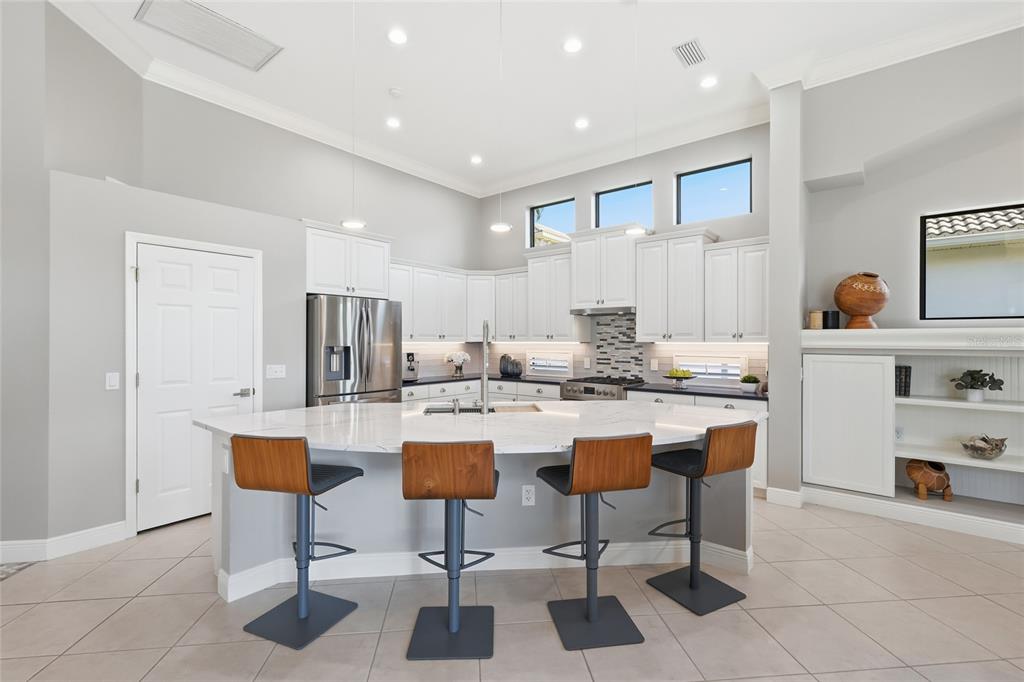 7060 Whitemarsh Circle Lakewood Ranch, FL 34202 - Photo 11 of 56 a kitchen with a dining table chairs sink and cabinets