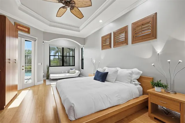 a bedroom with a bed and a flat tv screen on dresser