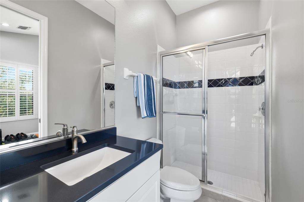 7060 Whitemarsh Circle Lakewood Ranch, FL 34202 - Photo 19 of 56 a bathroom with a sink vanity granite toilet and shower