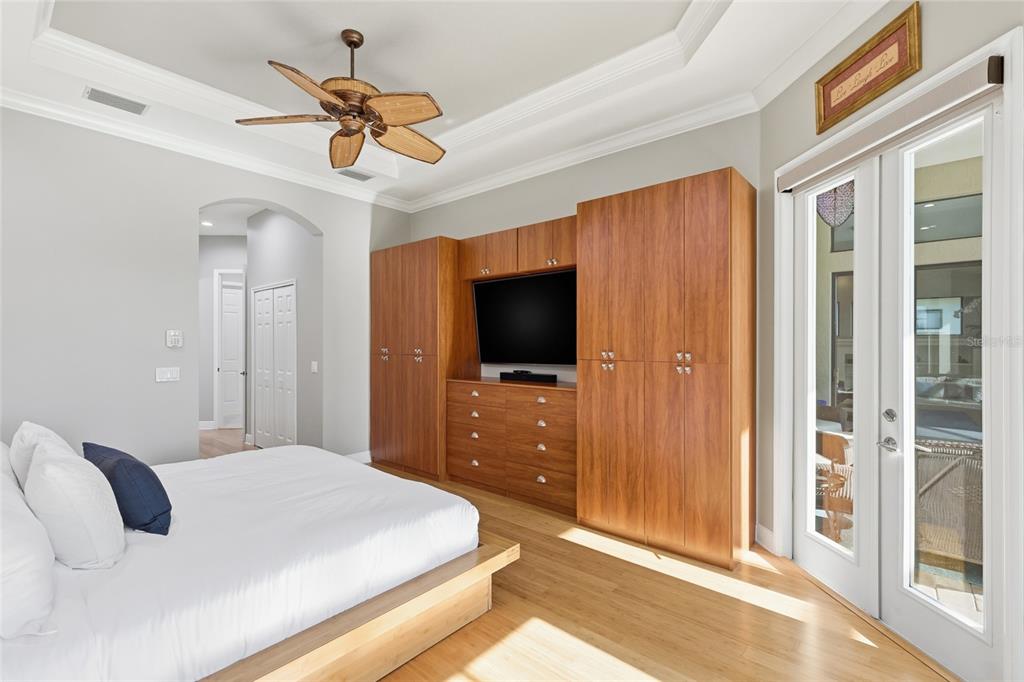 7060 Whitemarsh Circle Lakewood Ranch, FL 34202 - Photo 20 of 56 a bedroom with a bed and a flat tv screen on dresser