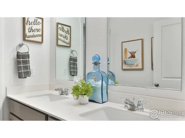 a bathroom with a sink mirror and vanity