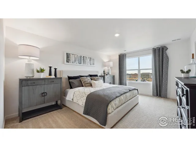 a en suite bathroom with a double vanity sink a mirror and a bathtub