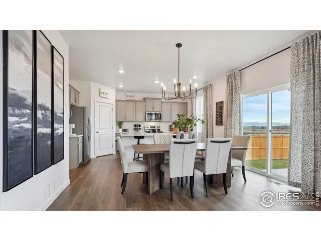 a living room with stainless steel appliances kitchen island granite countertop furniture and a dining table