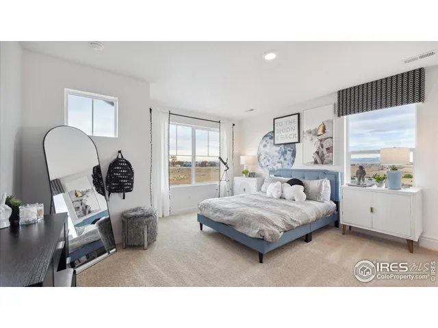 a living room with a bed furniture and a window