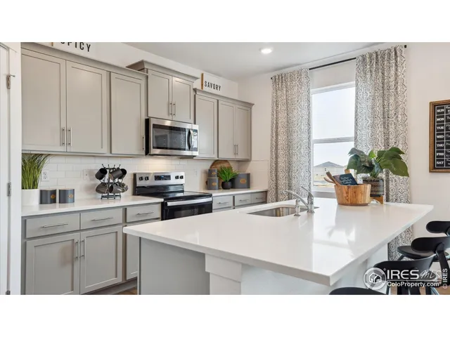 a kitchen with stainless steel appliances granite countertop a sink a stove and cabinets