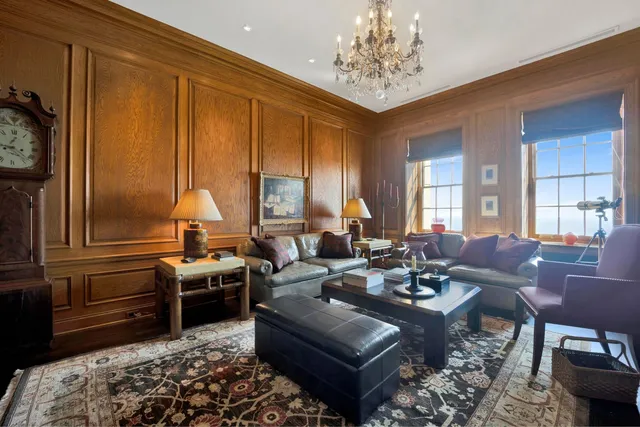 a living room with furniture and a chandelier