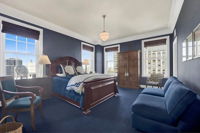 a bedroom with a bed couch and window