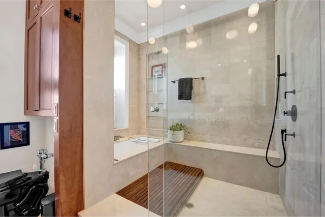 a bathroom with a granite countertop sink a mirror and shower