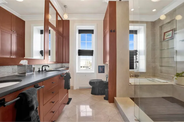 a spacious bathroom with a granite countertop sink mirror and double