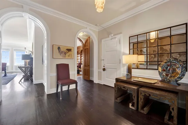 a living room with furniture a table and wooden floor