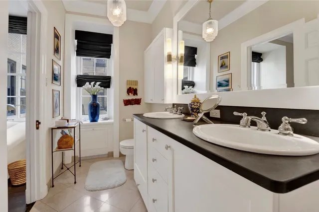 a bathroom with a sink double vanity granite and a mirror