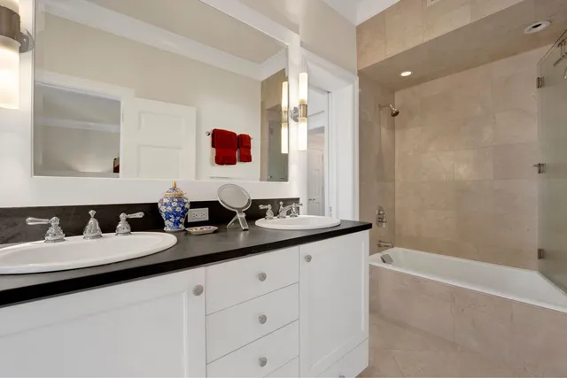 a bathroom with a tub sink and mirror