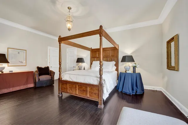 a bedroom with furniture and wooden floor